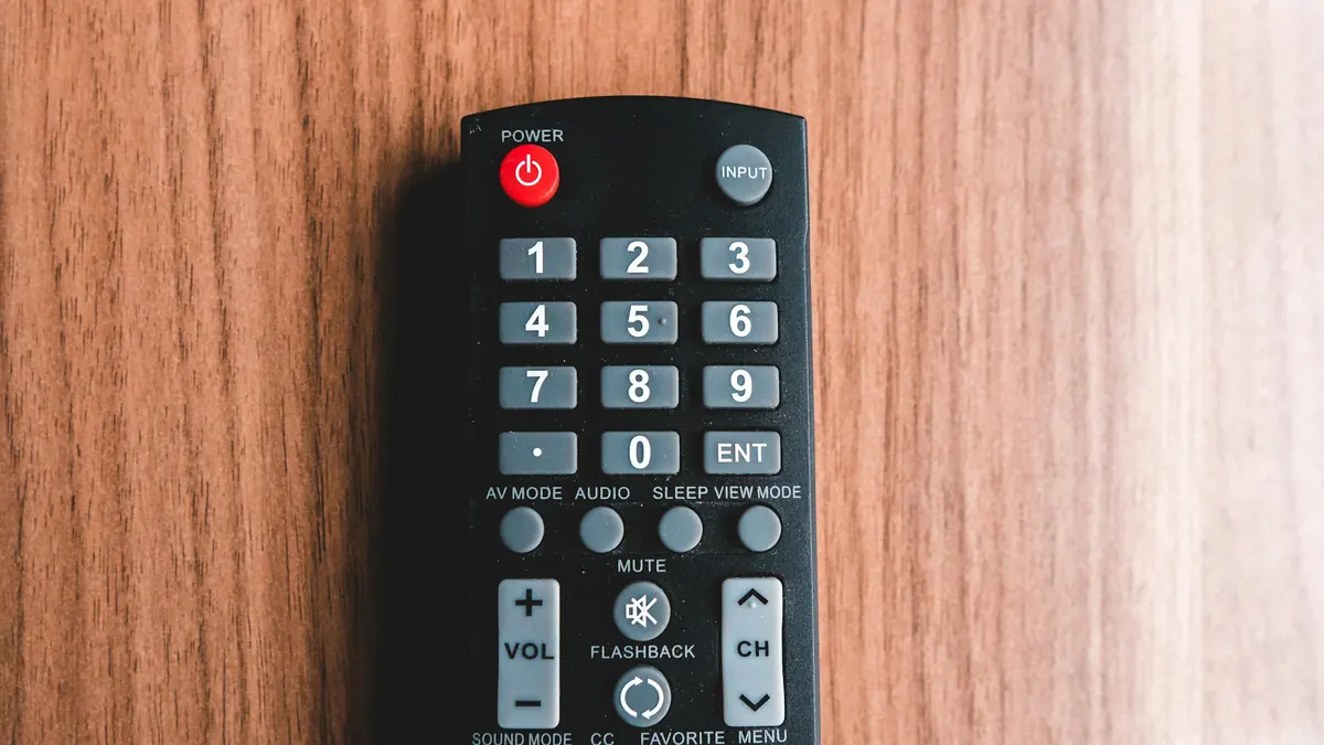 TV remote control lying on a wooden table