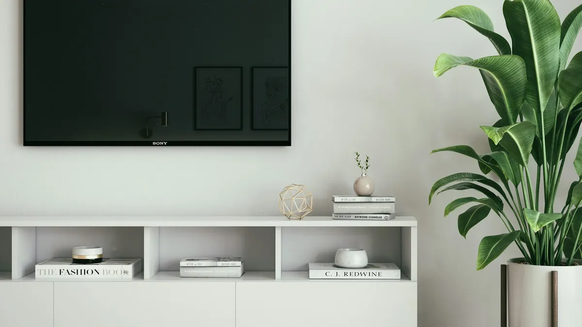 Wall-mounted television switched off in a quiet living room